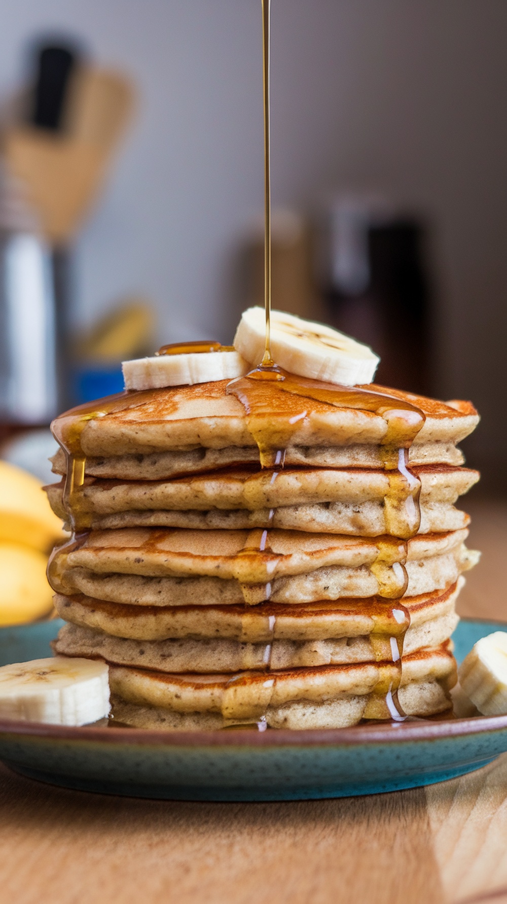 A stack of banana oatmeal pancakes topped with banana slices and syrup.