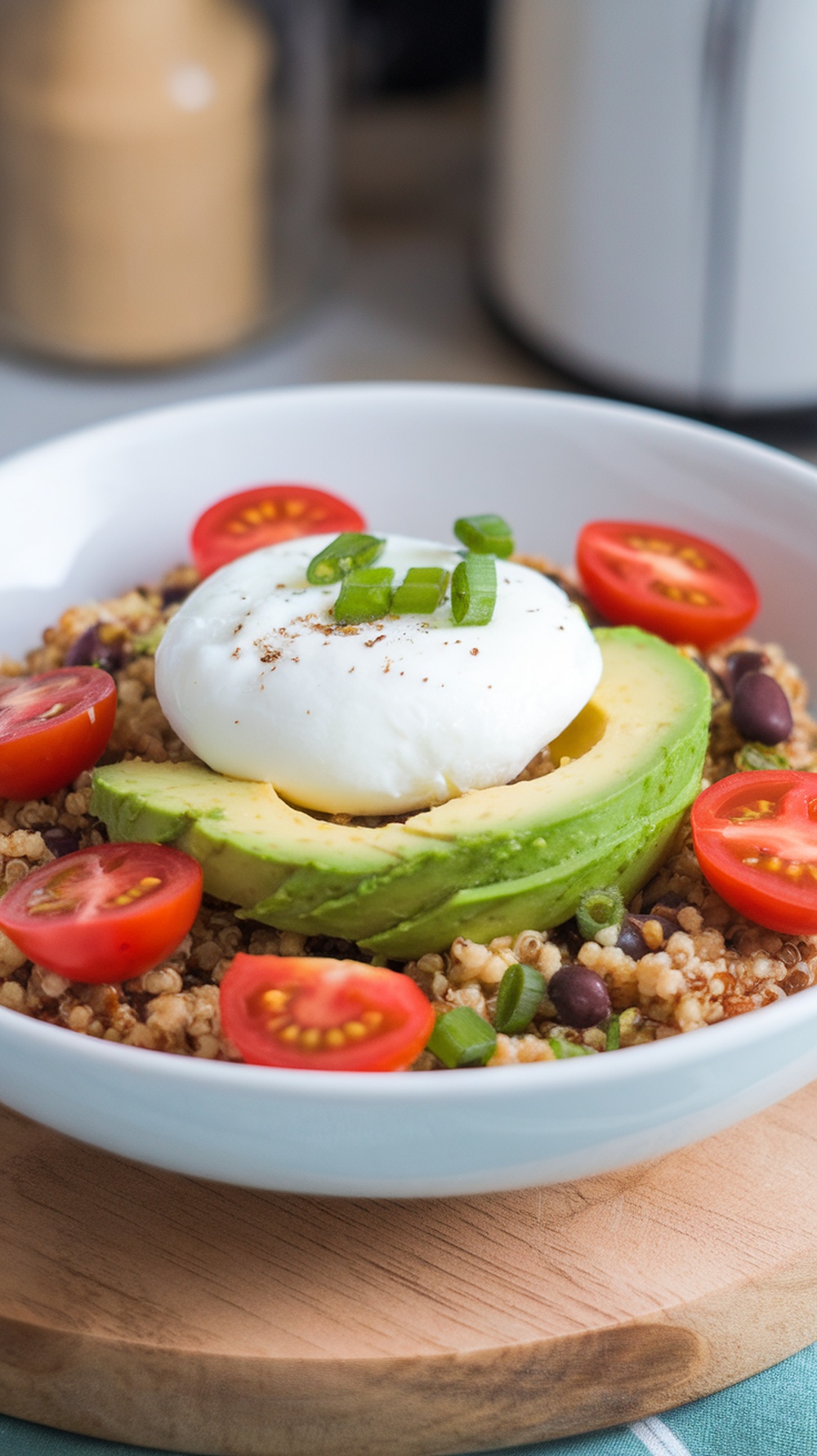 A savory quinoa breakfast bowl with avocado, cherry tomatoes, and a poached egg.